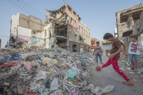 Yemeni children play in the rubble of buildings destroyed in an air raid.