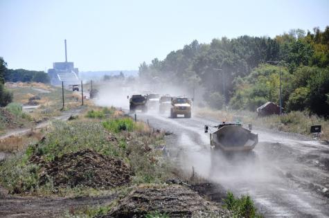 Dust particles rising from moving vehicles, contributing to air pollution and reduced visibility.