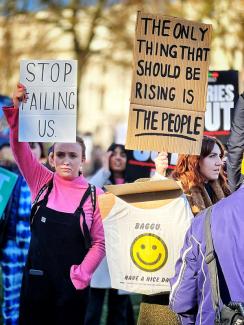 Two women protest in London about the cost of living crisis