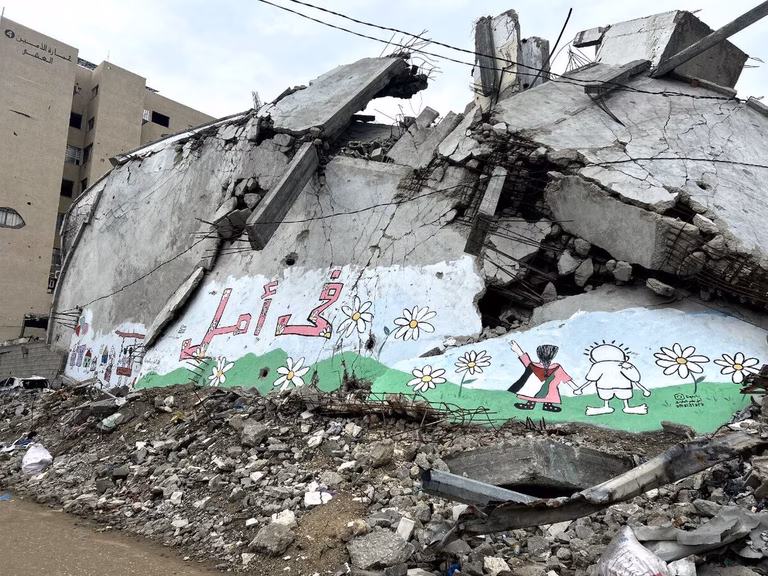  A mural painted on the rubble of a destroyed building in Al Thawra Street in Rimal, Gaza. The mural was created by Mostafa Mehna with 25 children from Gaza. The Arabic text reads "There is hope".