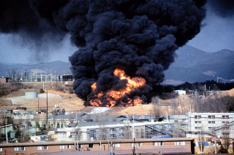 Smoke and flames billow from a fuel tank after an explosion at a U.S. occupied air base in Korea.