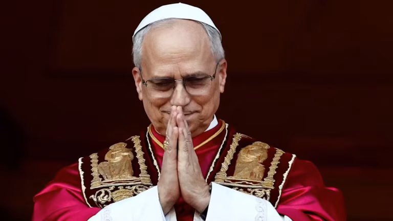 The new Pope Leo holds his hands in prayer position.